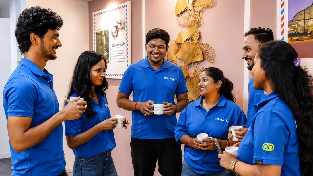 Onsurity teammates catching up over coffee together in the office